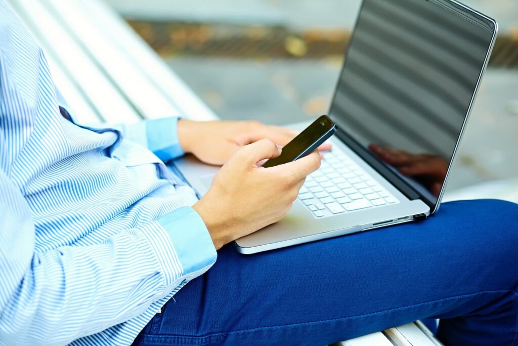 A bank building in Denmark or someone using online banking on a laptop.